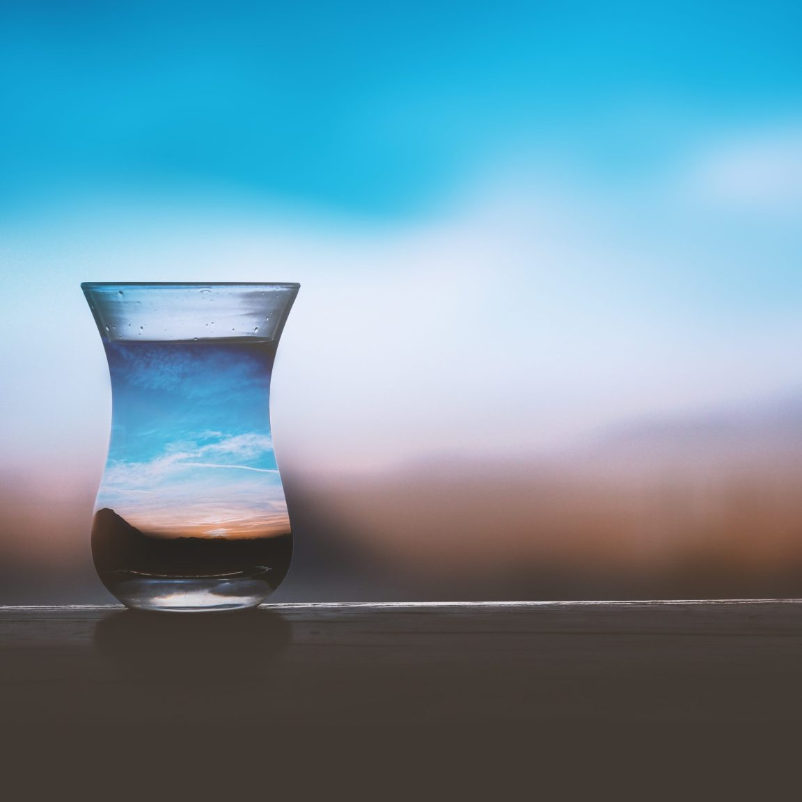 Glas mit Wasser und Landschaft als Symbol für nachhaltige Wasserstoff- und Energieprojekte (HyGo Projekt)